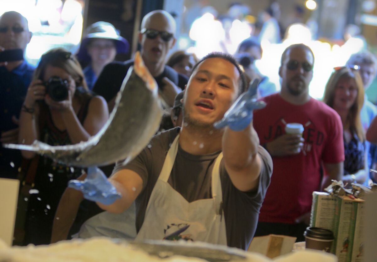 ...They're also part of the entertainment. Tossing fish is a tradition at the Pike Place Fish Market -- a show-stopping crowd pleaser for tourists and customers.