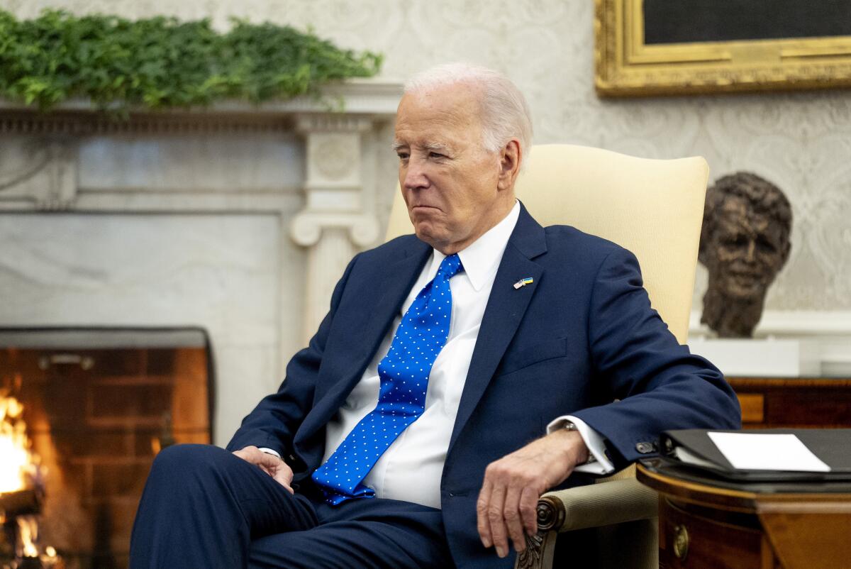 President Biden sits in the Oval Office 