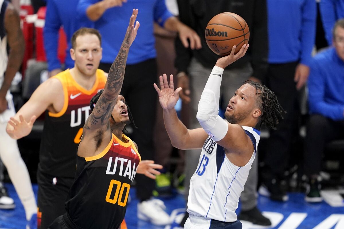 Utah Jazz guard Jordan Clarkson (00) defends against a shot by Dallas Mavericks guard Jalen Brunson (13) in the second half of Game 2 of an NBA basketball first-round playoff series, Monday, April 18, 2022, in Dallas. (AP Photo/Tony Gutierrez)