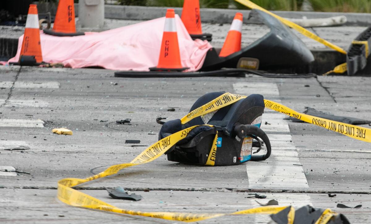 A baby car seat lies in the intersection 