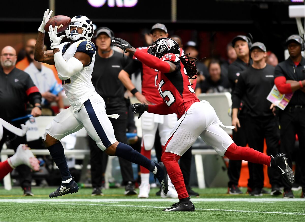Rams tight end Gerald Everett makes a catch in front of Atlanta safety Jamal Carter on Sunday at Mercedes-Benz Stadium.