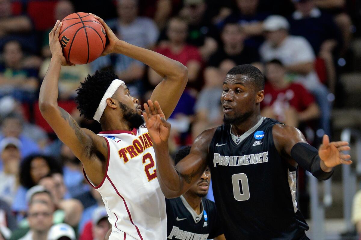 USC forward Malik Martin tries to protect the ball from the reach of Providence forward Ben Bentil during the first half.