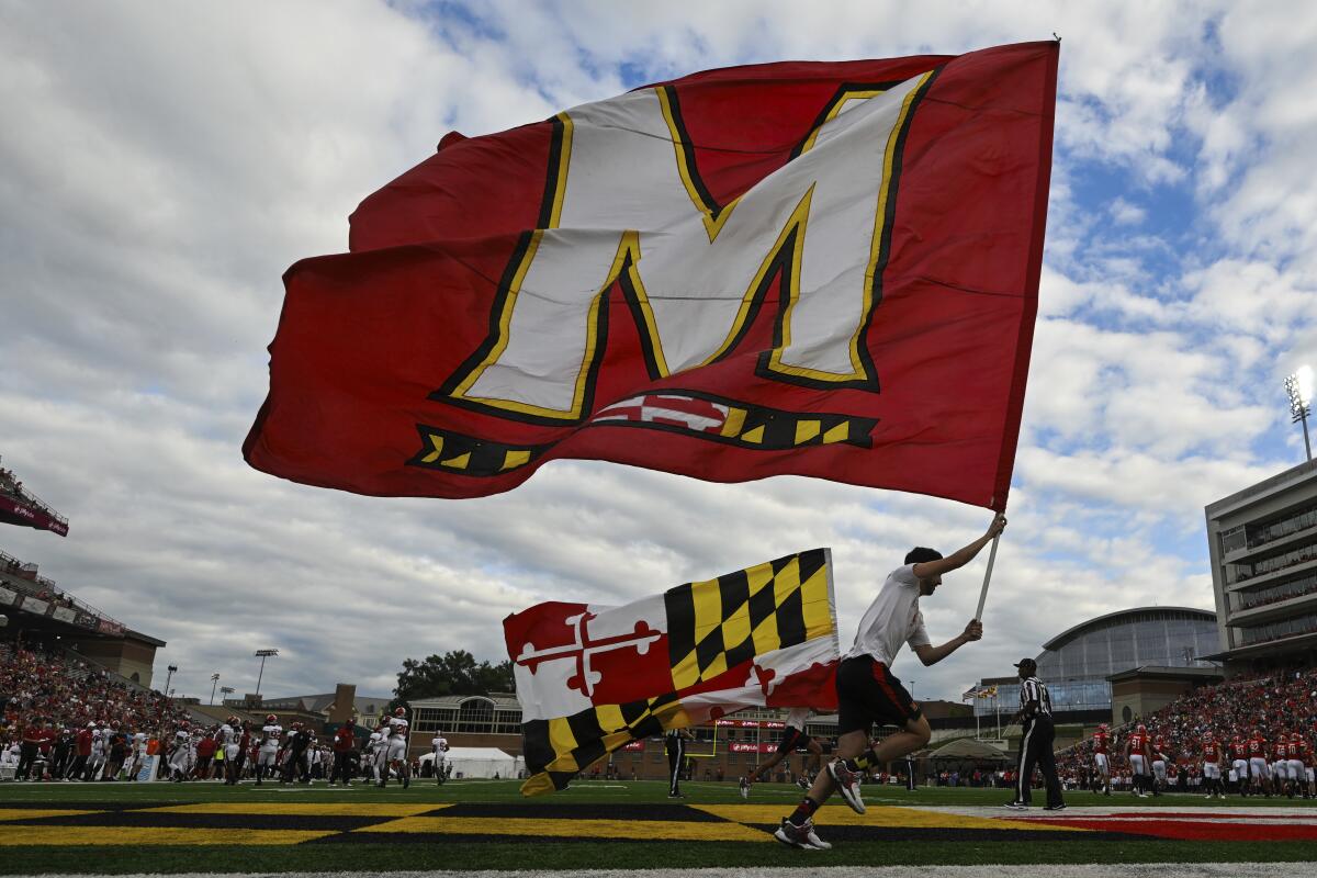 The Maryland state and university flag are run across the end zone after a touchdown during the first half of an NCAA college football game against Indiana, Saturday, Sept. 30, 2023, in College Park, Md.