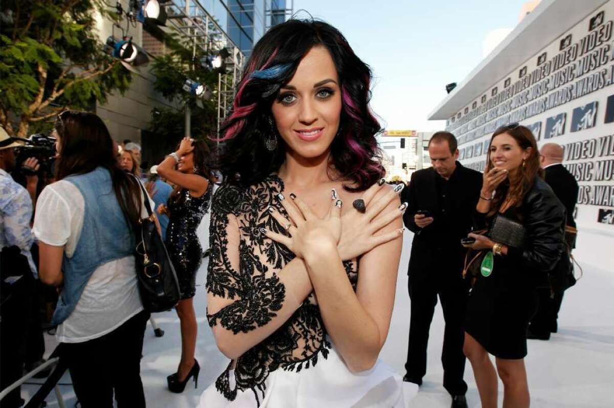 Katy Perry poses for the press in a skin-baring dress.
