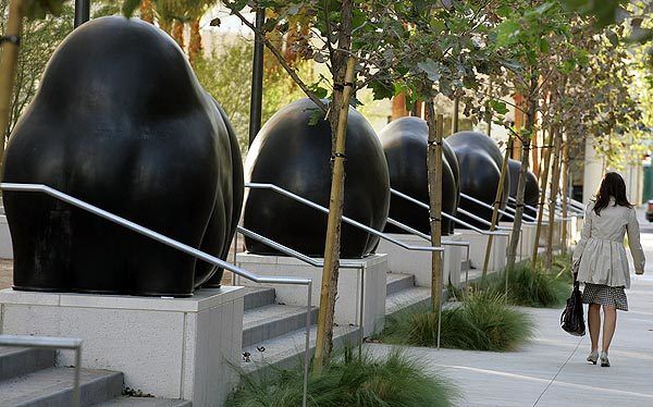 Public art costing $500,000 has been installed on the west side of the Los Angeles Police Department's new headquarters. Although the cast-bronze sculptures have been likened to six large black blobs, with two tall, skinny structures on either side, artist Peter Shelton of Los Angeles says the shapes are a rotund beast, two bison, two bears and two hippos.