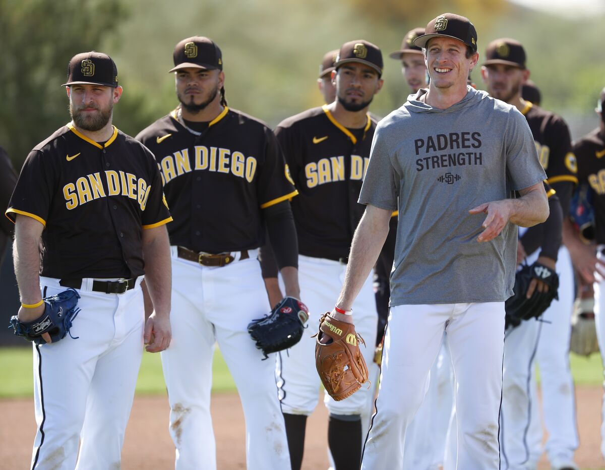 Tim Hill, right, and other Padres pitchers look on during a spring training practice.