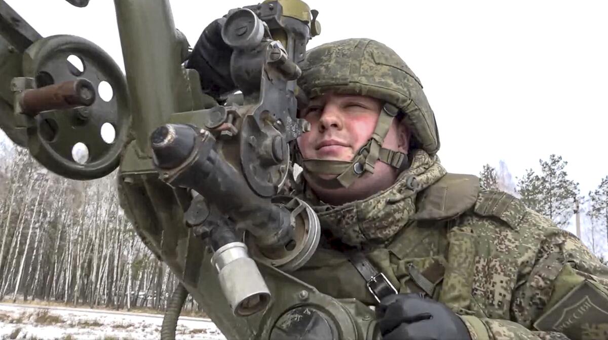 A soldier with a weapon during military drills at a firing range