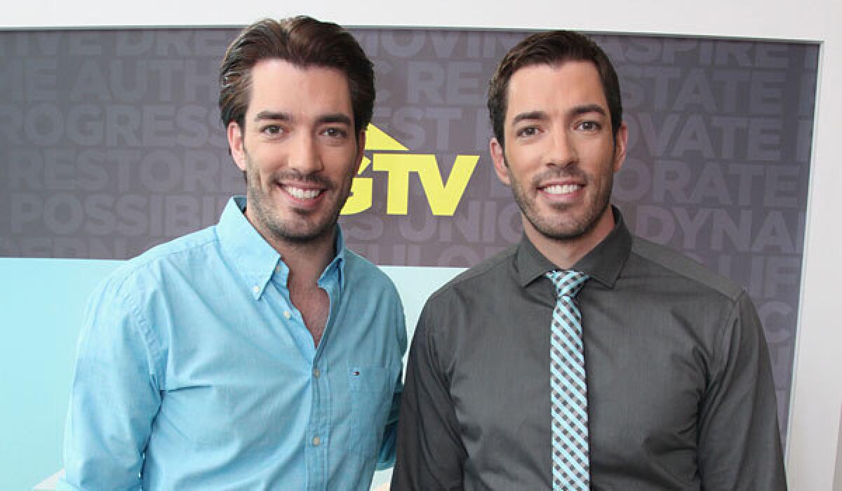Twin brothers Drew Scott, left, and Jonathan Scott from the new series "Brother vs. Brother."