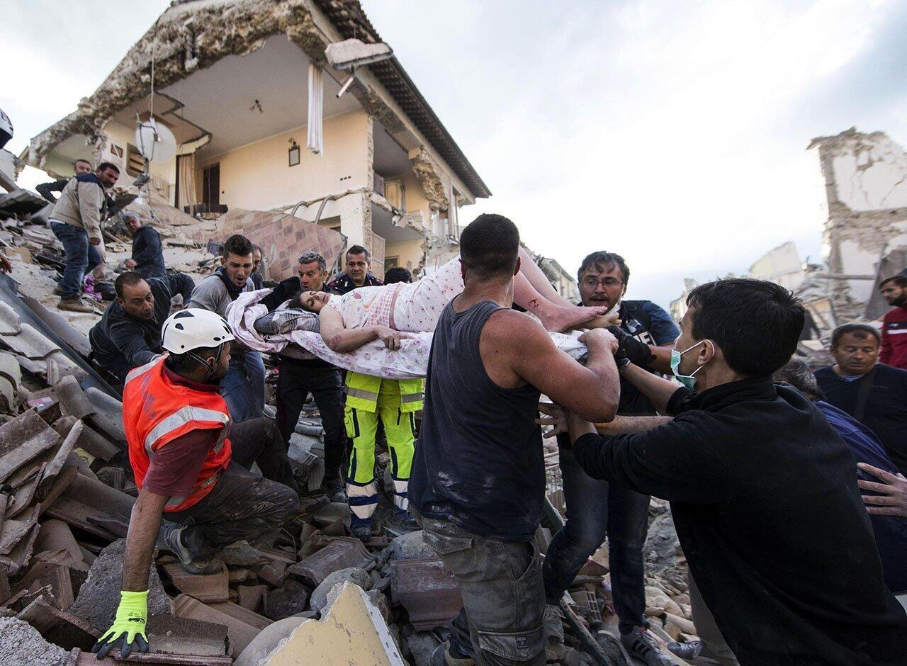 A rescued woman is carried away on a stretcher following an earthquake in Amatrice, Italy. The magnitude 6.2 quake struck at 3:36 a.m. and was felt across a broad swath of central Italy, including Rome where residents of the capital felt a long swaying followed by aftershocks.