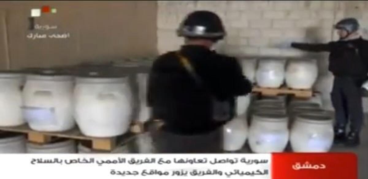 An Oct. 19 image from Syrian television shows inspectors from the Organization for the Prohibition of Chemical Weapons at work at an undisclosed location in Syria.