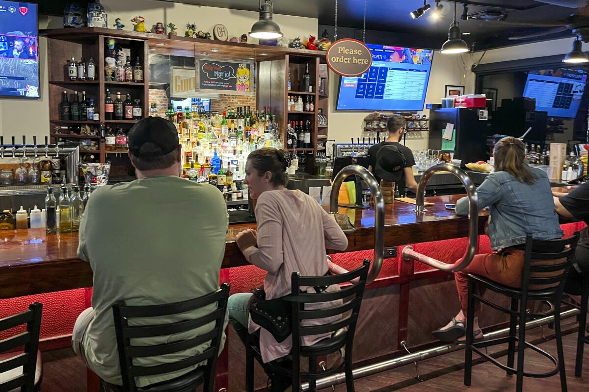 People sit at a bar.