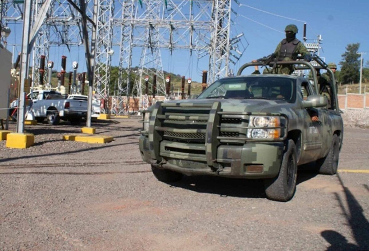 Soldiers protect technicians at an energy station after it was attacked in the State of Michoacan, Mexico.