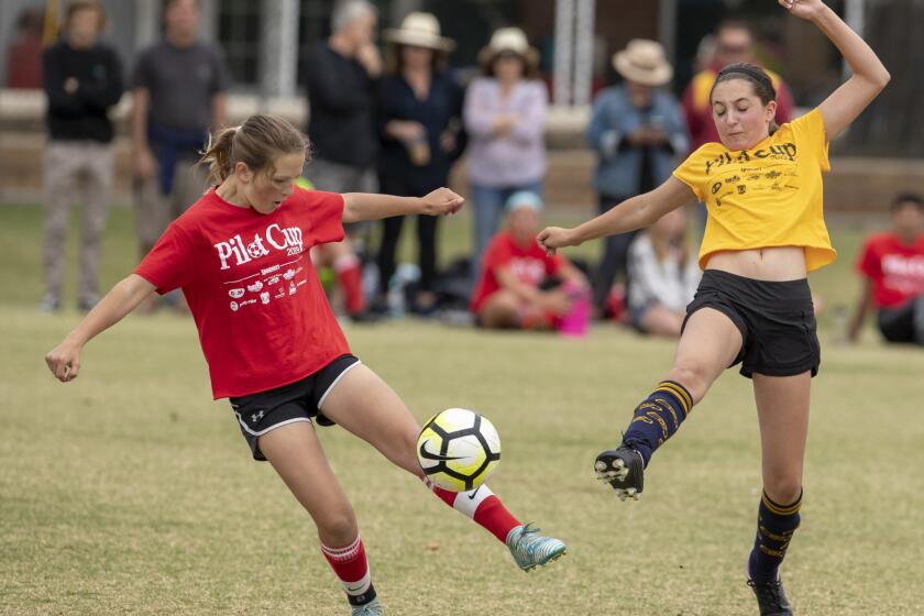 Costa Mesa Kaiser's Ella Woods battles for a ball against Corona del Mar Harbor Day's Maya Fishchbein in a girlsÕ fifth- and sixth-grade Gold Division quarterfinal match during the Daily Pilot Cup on Saturday, June 1.