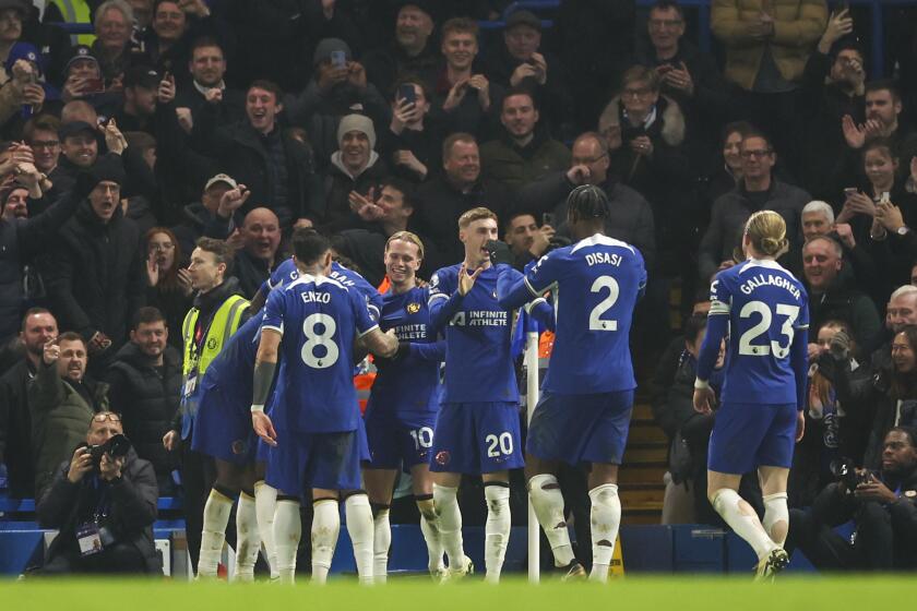 Chelsea's Mykhailo Mudryk celebrates with teammates after scoring his side's third goal during the English Premier League soccer match between Chelsea and Newcastle at Stamford Bridge stadium in London, Monday, March 11, 2024. (AP Photo/Ian Walton)