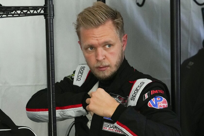 FILE - Kevin Magnussen, of Denmark, adjusts his driving suit after taking a turn driving on the track during a practice session for the Rolex 24 hour race at Daytona International Speedway in Daytona Beach, Fla., in this Friday, Jan. 29, 2021, file photo. Magnussen had not won a race in eight years when he lost his seat in Formula One and needed to find a new series. The Danish driver settled on racing a sports car in the United States for Chip Ganassi because Ganassi is committed to winning races. (AP Photo/John Raoux, File)