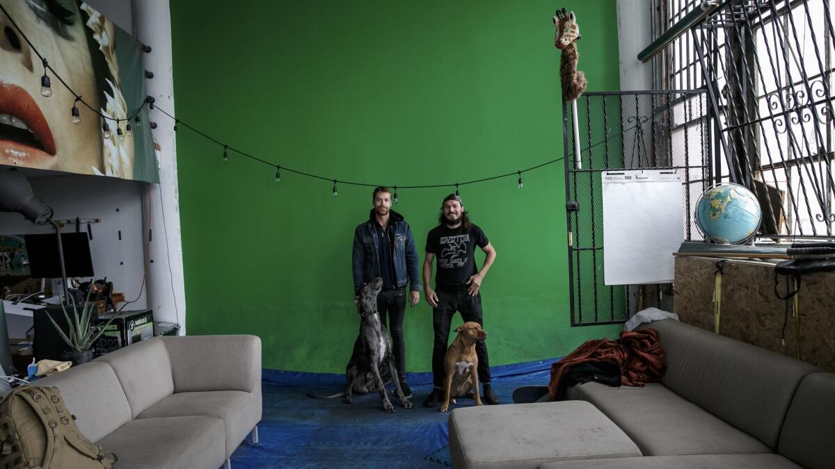 Matt Natoli, right, with his roommate Parker Francis at his Pico Boulevard loft. Many tenants had turned their lofts into galleries or hosted photo shoots and events.