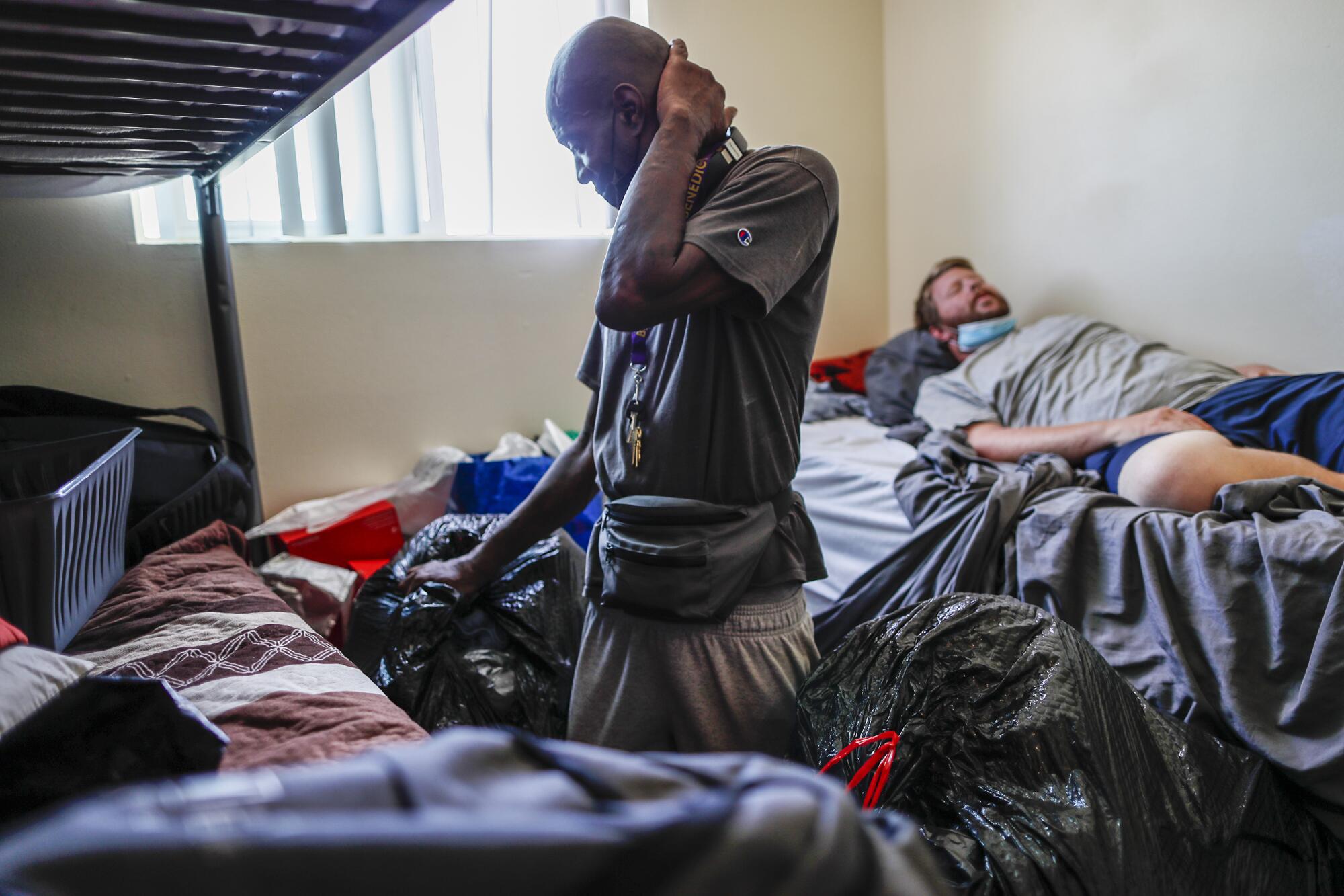 Donald Winston packs his belongings as he prepares to move into a new apartment after living in this homeless shelter. 