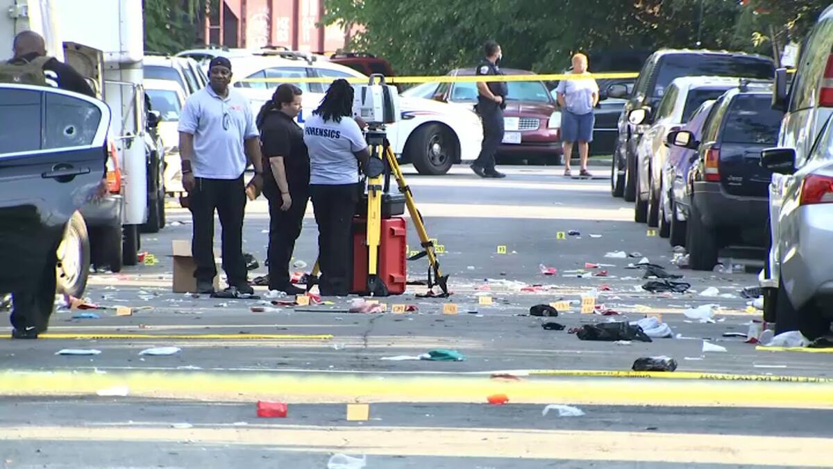In this image from video, law enforcement work the scene of a shooting Sunday in Washington, D.C.