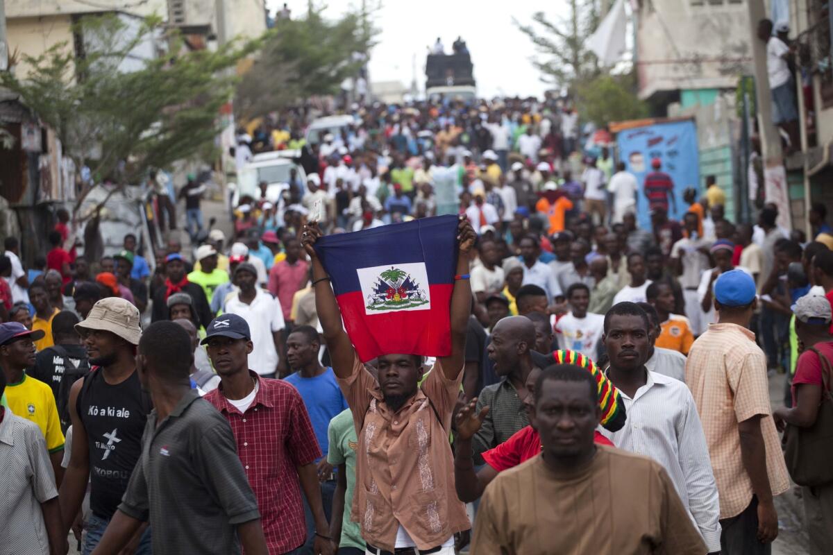 Demonstrators protest the government of President Michel Martelly in Port-au-Prince, Haiti, on Sunday.