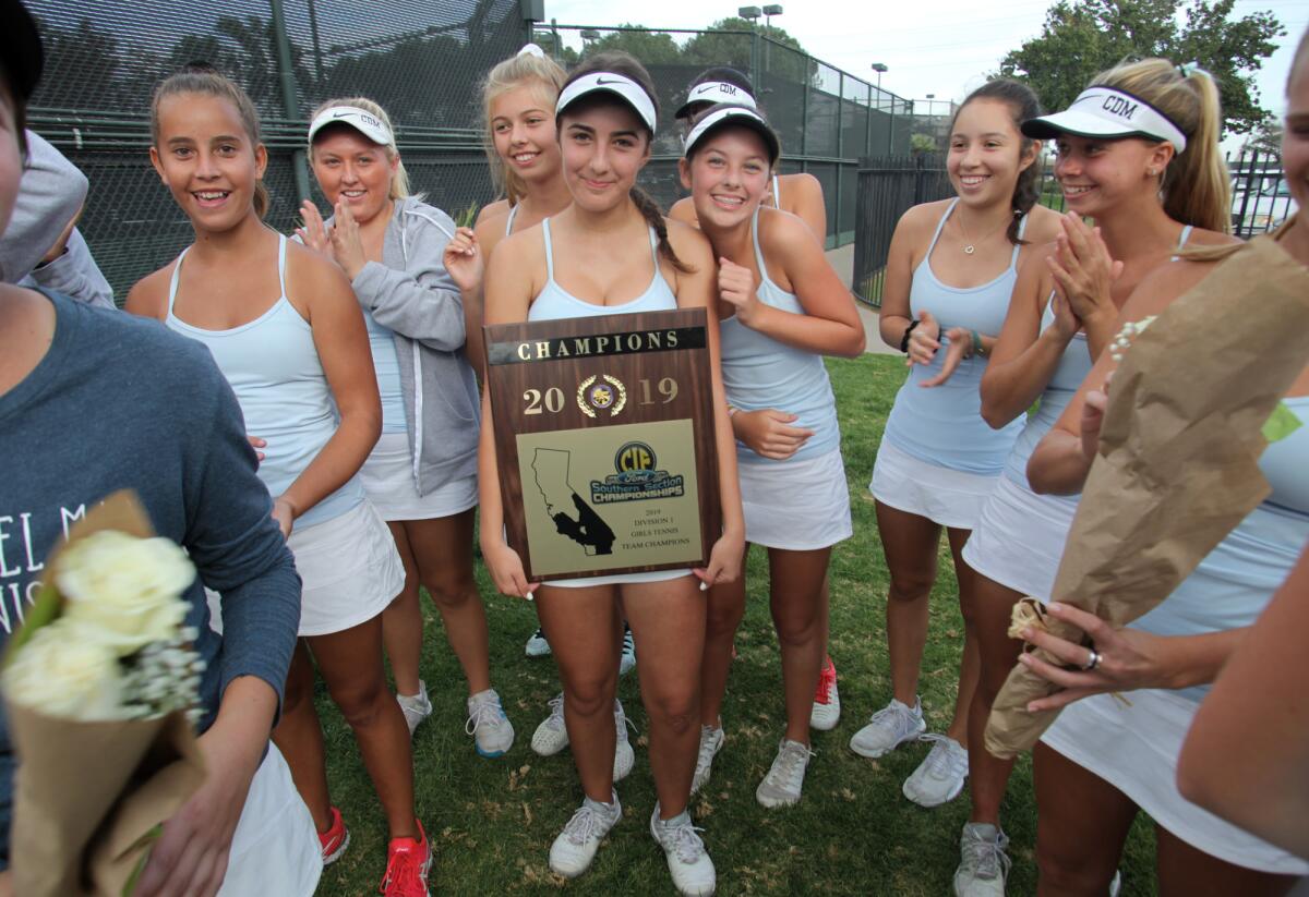 Corona del Mar's Kristina Veskovic holds the CIF Southern Section Division 1 championship plaque after the Sea Kings beat Marlborough in the final at the Claremont Club on Friday.
