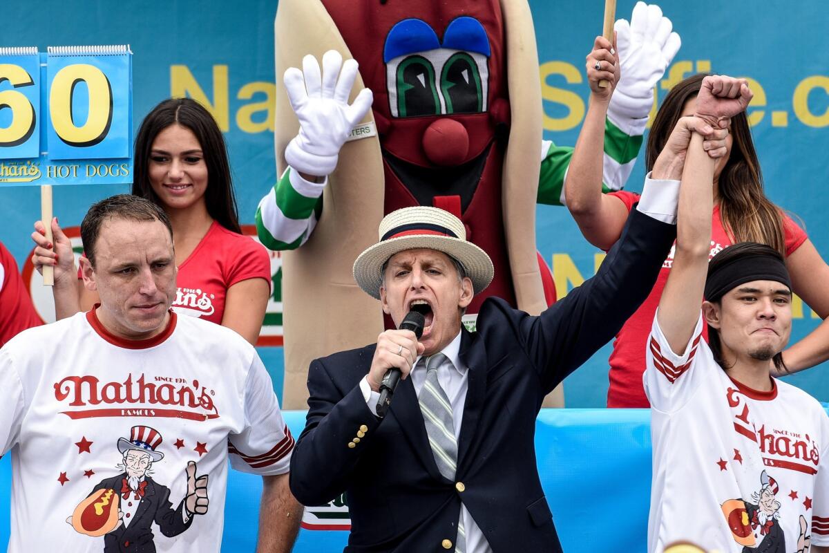Matt Stonie, right, defeated eight-time champion Joey Chestnut after eating 62 hot dogs at the Nathan's Famous Fourth of July international hot dog-eating contest in Coney Island, N.Y.