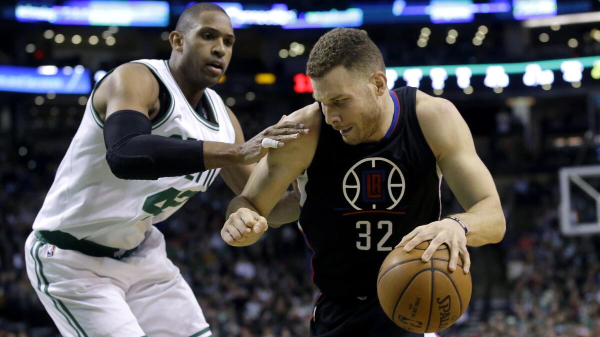 Clippers forward Blake Griffin (32) drives against Celtics center Al Horford during the first half of a game in Boston.