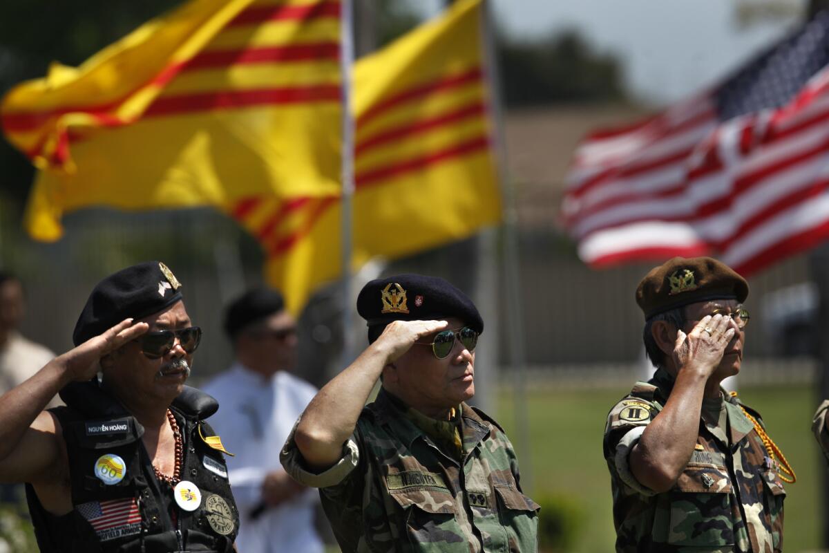 Former members of the South Vietnamese military salute during a 2013 ceremony held inside Westminster Memorial Park to mark the April 30, 1975, fall of Saigon.