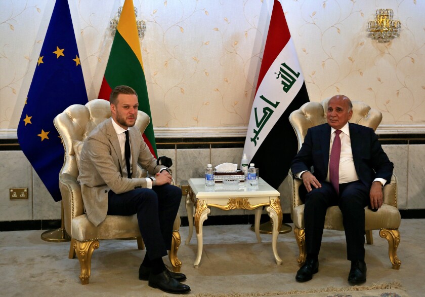 Iraqi Foreign Minister Fouad Hussein, right, meets with visiting Lithuanian Foreign Minister Gabrielius Landsbergis, in Baghdad, Iraq, Thursday, July 15, 2021. (AP Photo/Khalid Mohammed)