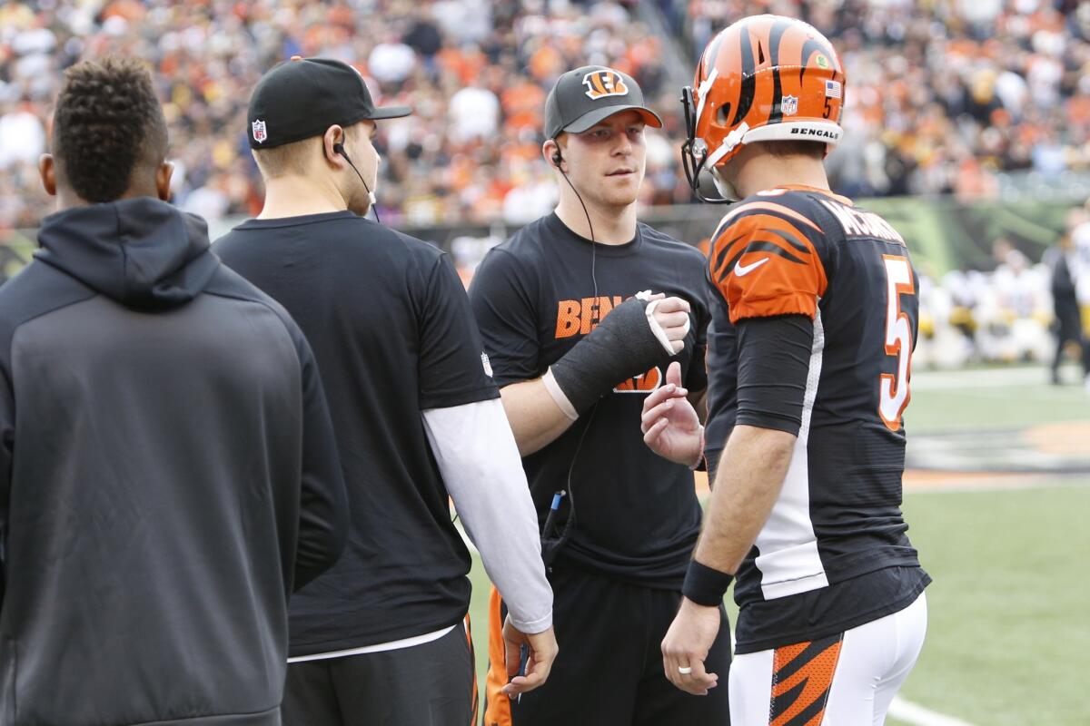Bengals quarterback Andy Dalton, center right, speaks with backup AJ McCarron (5) after Dalton was taken out of the game for an injury.