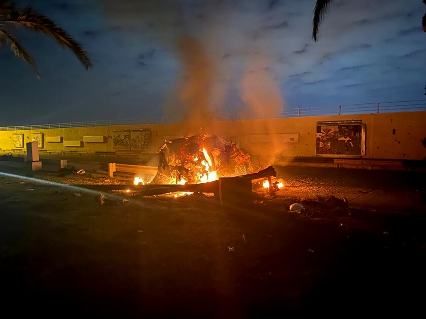 The remains of a vehicle burn at the Baghdad airport