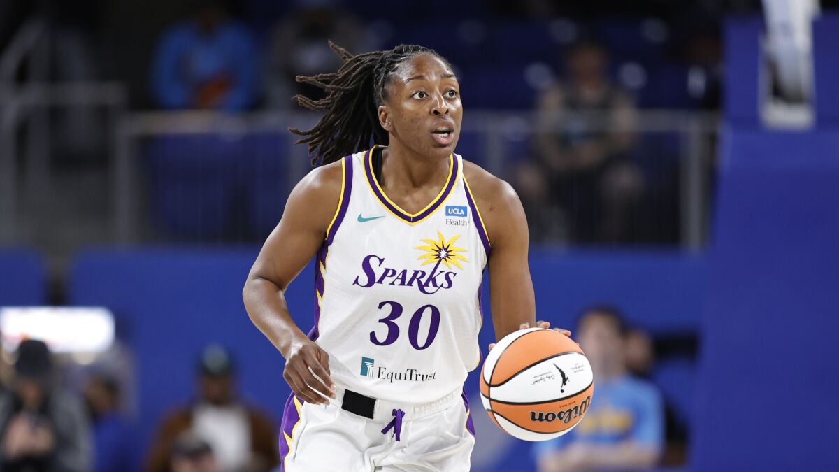 Sparks star Nneka Ogwumike brings the ball up the court against the Chicago Sky.