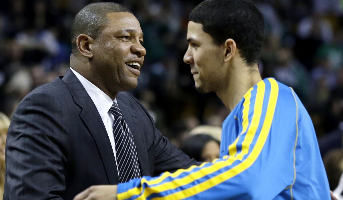 Doc Rivers, then the Boston Celtics' coach, greets his son, Austin, when he was a rookie with New Orleans.