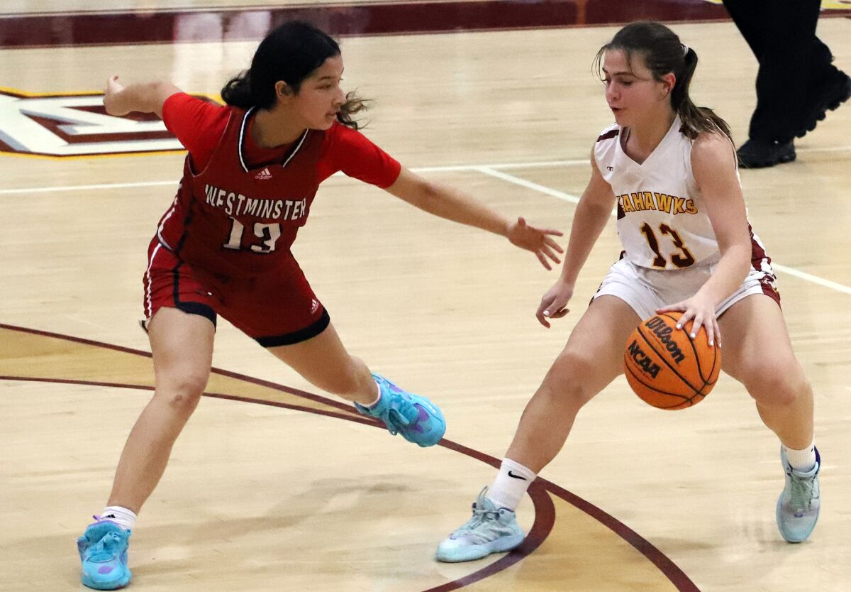 Ocean View's Angelina Bado, right, dribbles around Westminster's Kiana Salcedo (13) in a Golden West League game.