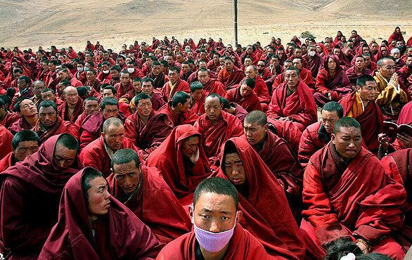 Tibetan monks gather outside their destroyed monastery in Jiegu, Yushu county, in China's northwestern Qinghai province. China declared a national day of mourning for victims of last week's earthquake as rescuers battled altitude sickness and bad weather conditions in the Tibetan disaster zone.