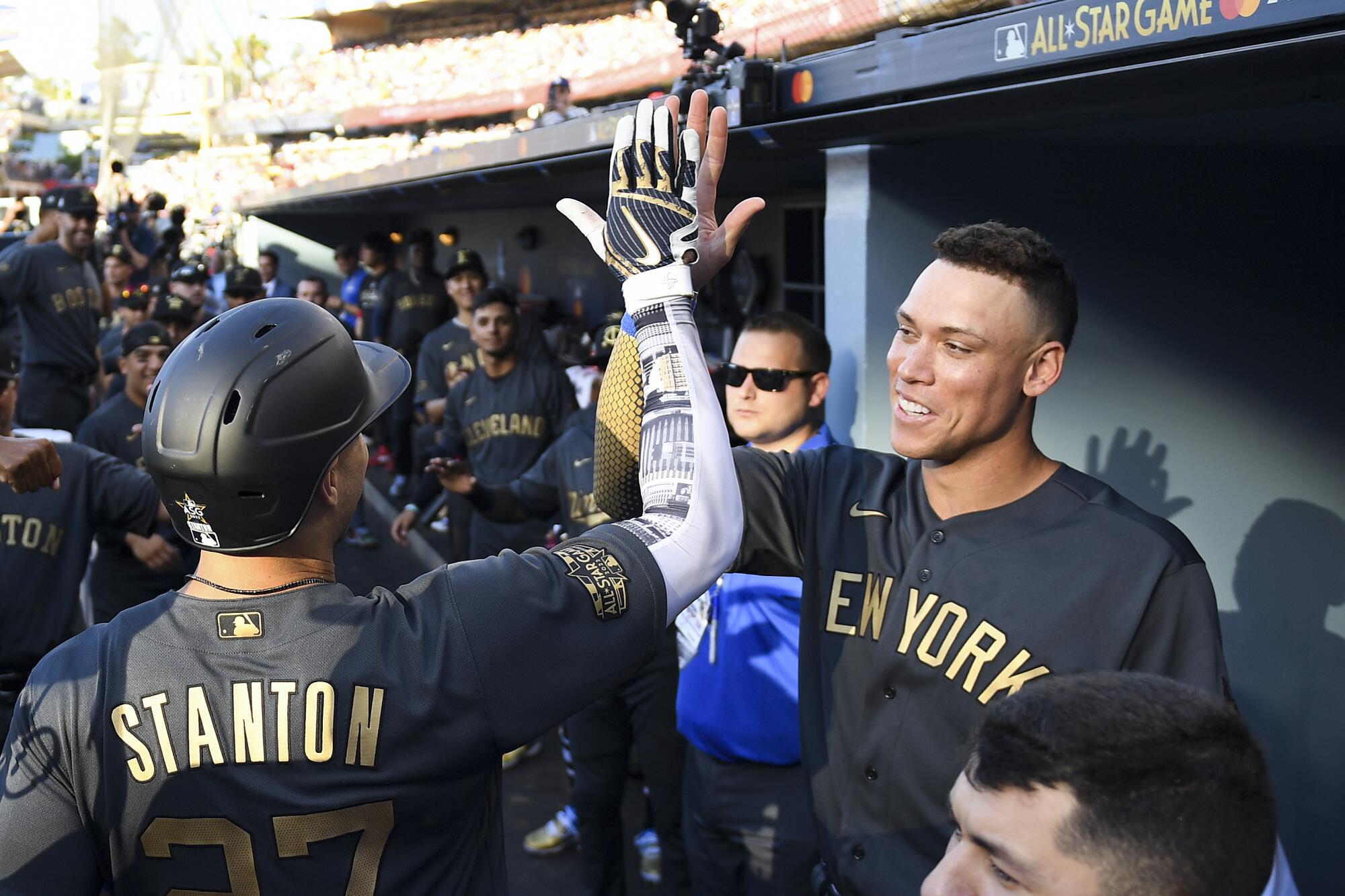 New York Yankees outfielder Giancarlo Stanton, left, celebrates with teammate Aaron Judge after hitting a two-run home run.