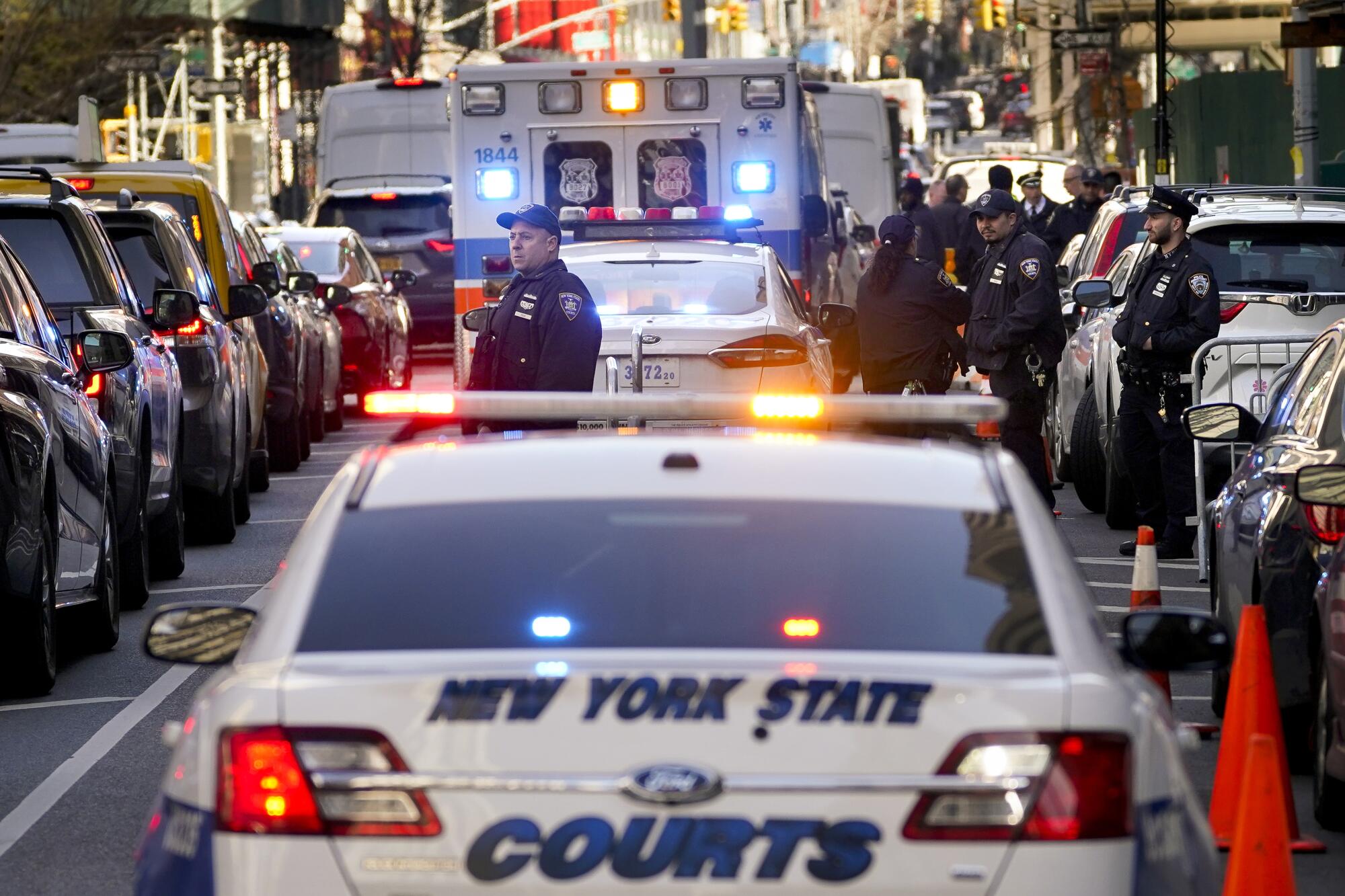 Police cars line a street in New York.