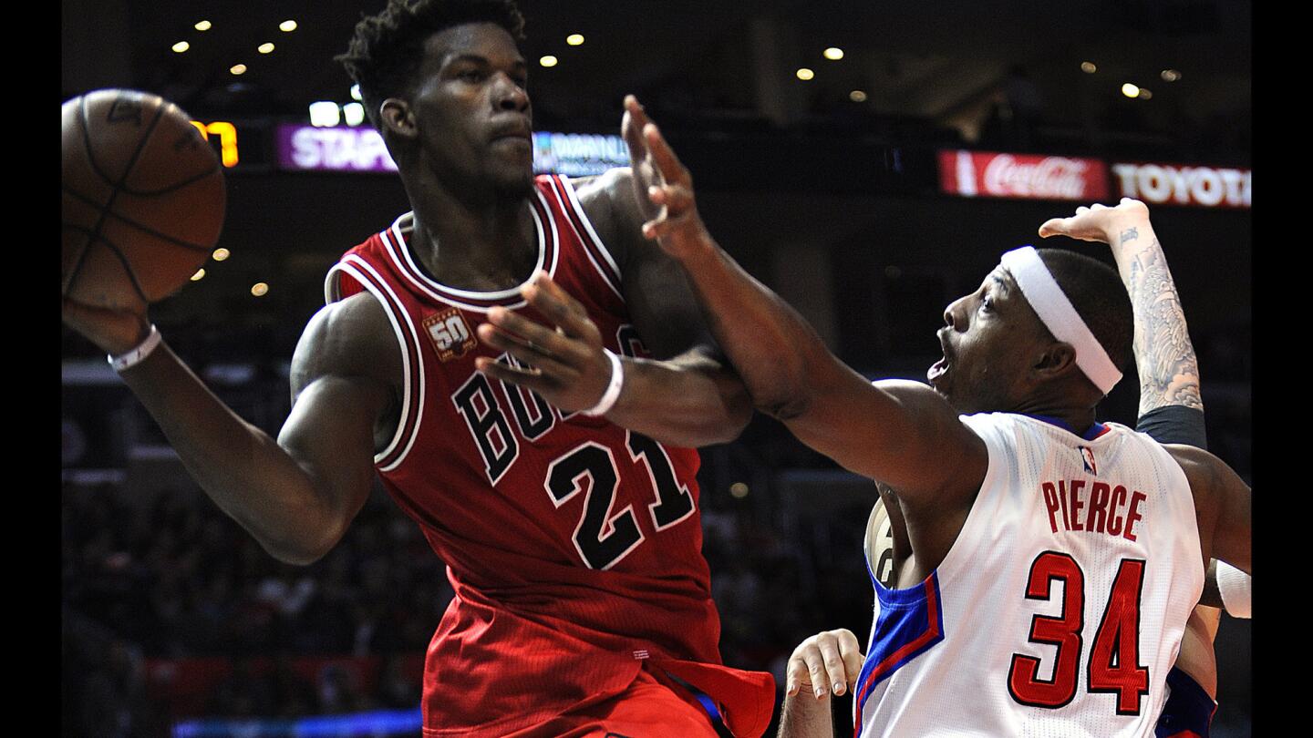 The Clippers' Paul Pierce, right, reaches to block a pass by the Chicago Bulls' Jimmy Butler at Staples Center on Sunday.