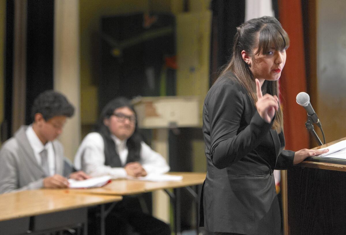 Eighth-grader Alessandra Salguero makes a point to the opposing team during a debate on homelessness at Charles Drew Middle School in South L.A. The students worked on building skills through the debate, rather than just reading books and taking exams.