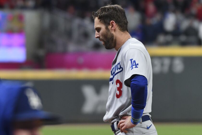 Atlanta, GA - October 16: Los Angeles Dodgers' Chris Taylor walks back to the dugout after being caught in a rundown.