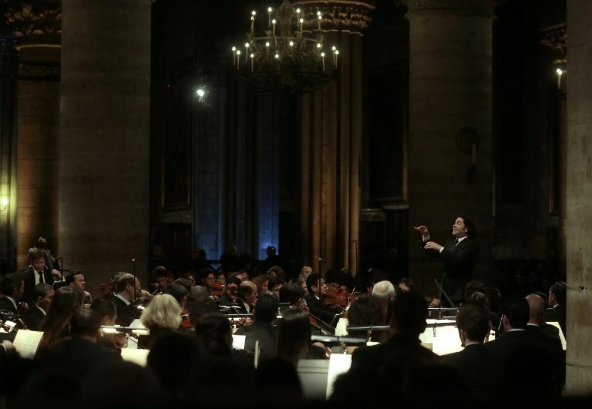 Gustavo Dudamel conducts the Orchestre Philharmonique de Radio France during a rehearsal of Berlioz's "Requiem" at the Notre Dame cathedral in Paris.