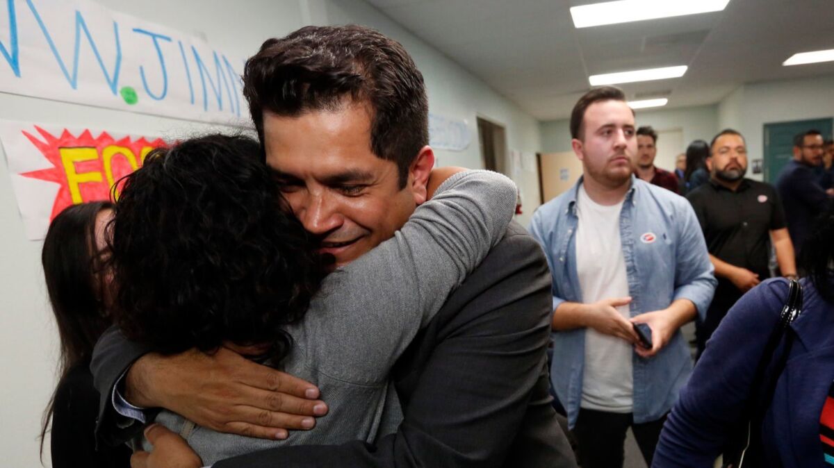 California State Assemblyman Jimmy Gomez, a candidate for the 34th Congressional District seat, hugs a supporter at election night headquarters in Highland Park.