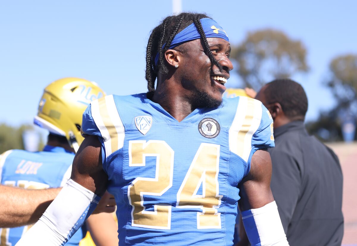 Qwuantrezz Knight smiles from the UCLA sideline during a game.