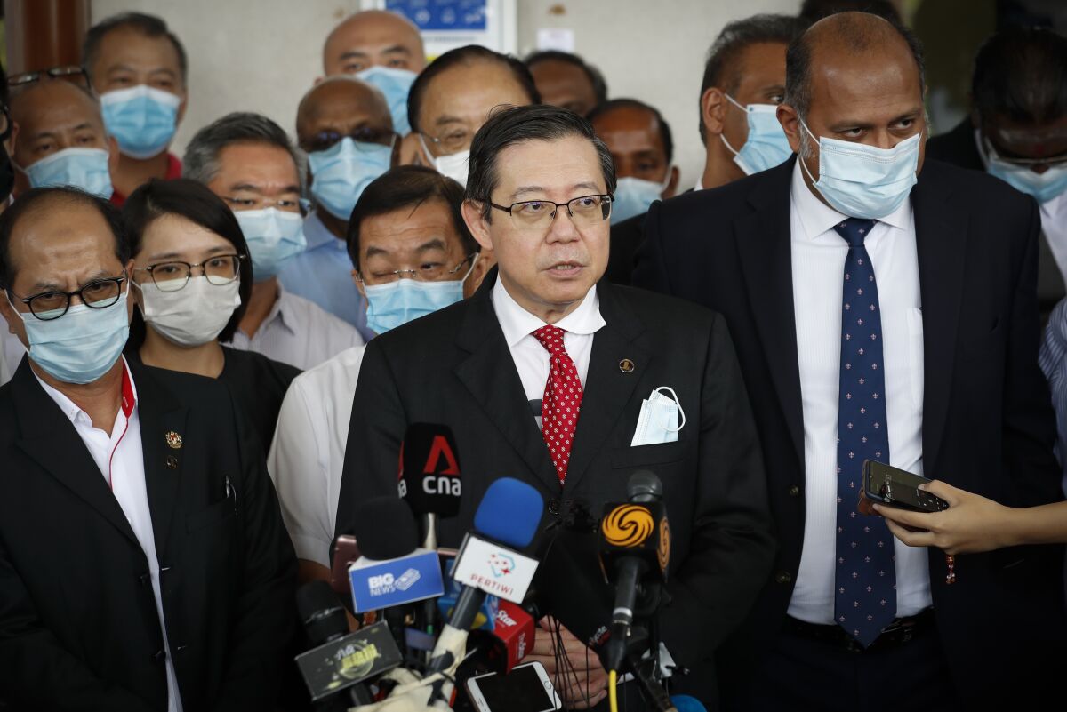 Former finance minister Lim Guan Eng speaks to media outside court house in Kuala Lumpur, Friday, Aug. 7, 2020. Lim has been charged with corruption over a $1.5 billion undersea tunnel project. Lim was part of a reformist government ousted in March, and his party slammed the criminal charge as political persecution by the new government. (AP Photo/Vincent Thian)
