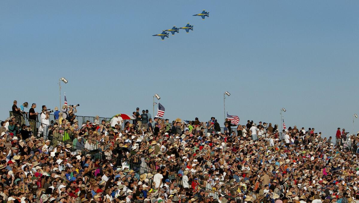 A U.S. Navy Blue Angels after performing a maneuver regroups behind the main bleacher view area. — Nelvin C. Cepeda