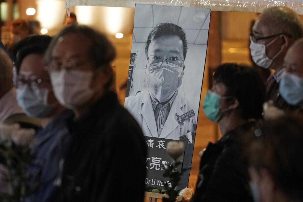 People attend a vigil for Chinese Dr. Li Wenliang, who was reprimanded for warning about the outbreak of the new coronavirus, in Hong Kong in early February.