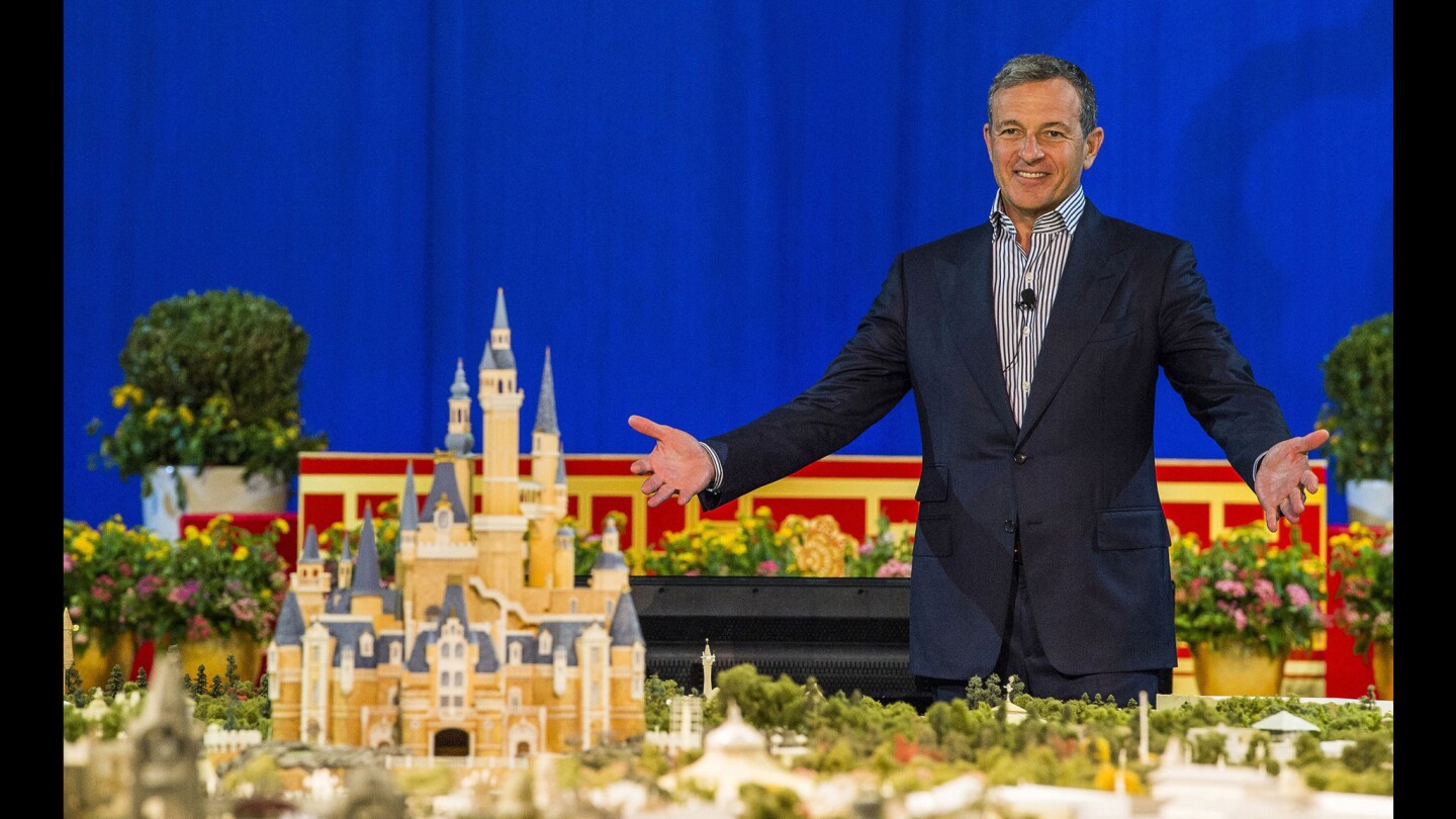 Bob Iger, Disney's chairman and chief executive, unveils a huge model of the Shanghai Disney Resort in a presentation at the Shanghai Expo Centre.