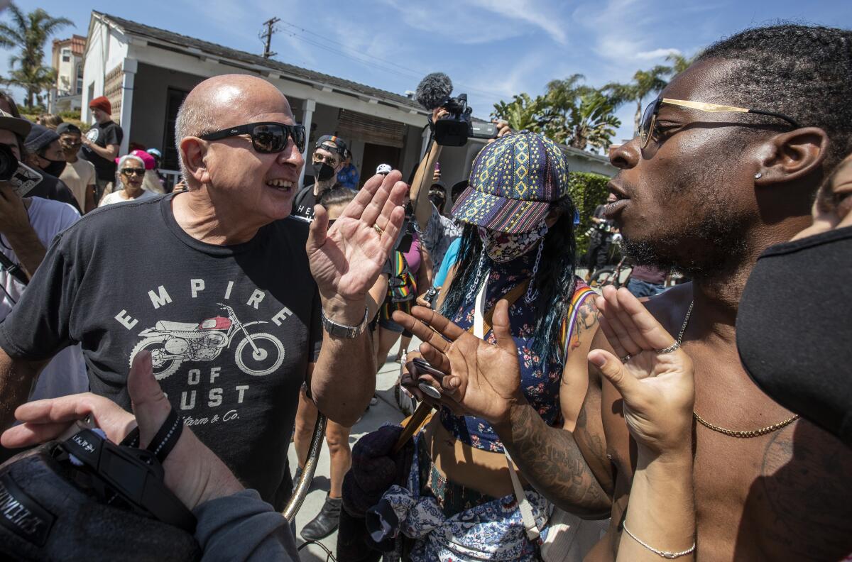 Protesters and counter-protesters argue at a rally.