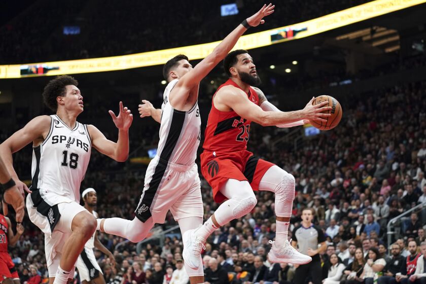 Toronto Raptors guard Fred VanVleet (23) shoots against San Antonio Spurs forward Isaiah Roby (18) and forward Doug McDermott during the first half of an NBA basketball game Wednesday, Feb. 8, 2023, in Toronto. (Arlyn McAdorey/The Canadian Press via AP)