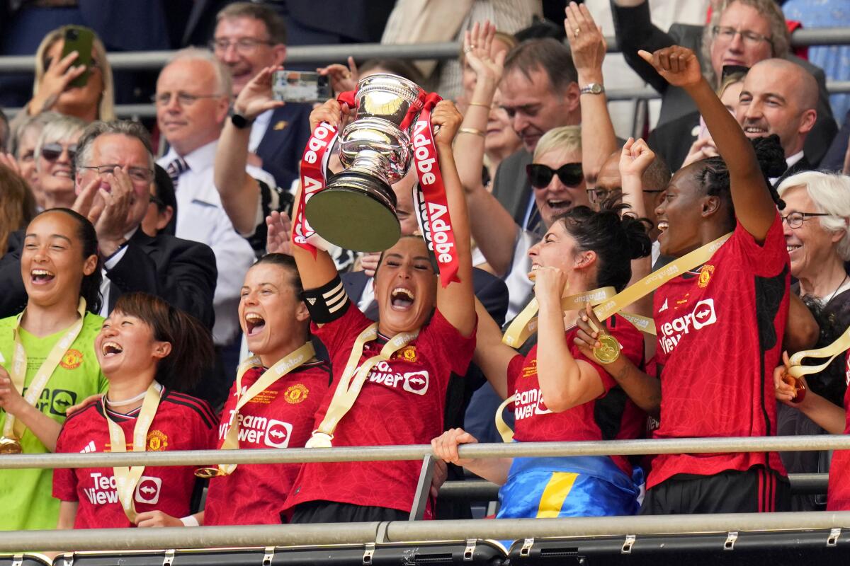 Katie Zelem lifts the trophy after Manchester United won the Women's FA Cup at Wembley Stadium in London on May 12.