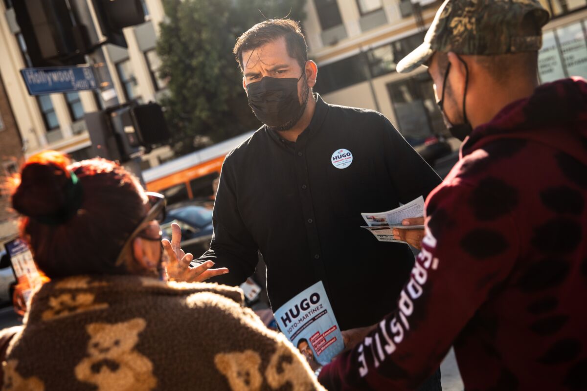 Hugo Soto-Martinez, a candidate for Los Angeles City Council, speaks with visitors to a farmer's market in Hollywood.